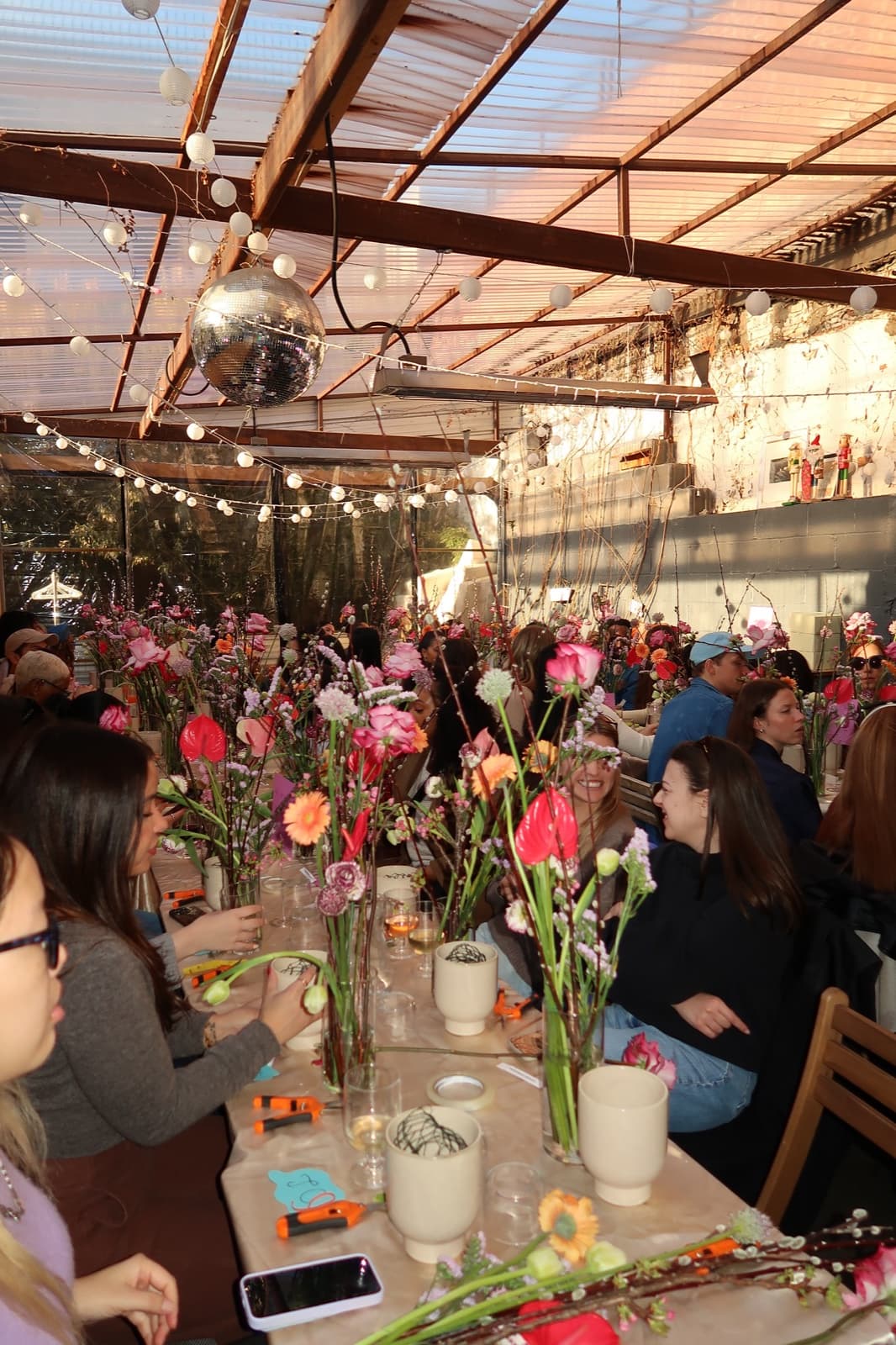 A Wingmate flower workshop under string lights