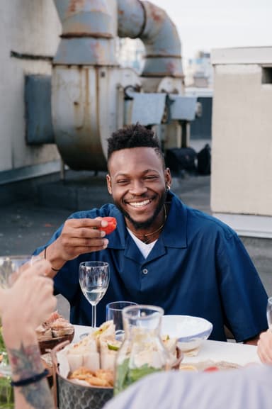 Man smiling with strawberry